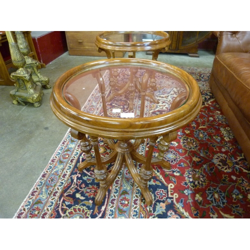 28 - A pair of Regency style mahogany and glass topped circular occasional tables