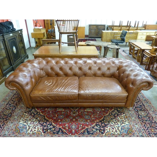 29 - A chestnut brown leather Chesterfield settee