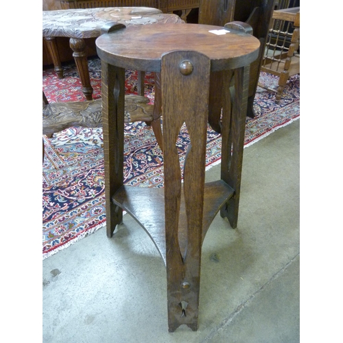 4 - An Arts and Crafts oak circular occasional table