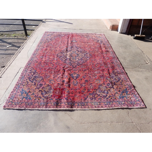 43 - A Persian red ground Mashad rug, 305 x 207cms, a/f