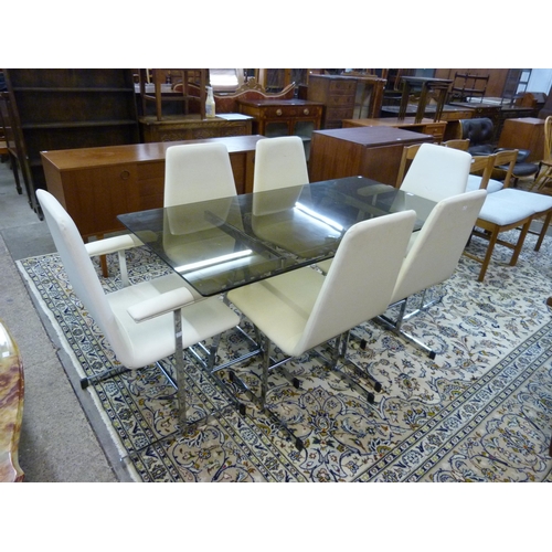 79 - A 1970's Pieff chrome and glass topped trestle dining table and six chairs, designed by Tim Banks