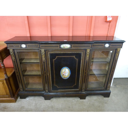 9 - A French ebonised and gilt metal side cabinet, mounted with Sevres style porcelain plaques