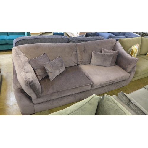 1340 - An aubergine velvet four seater sofa