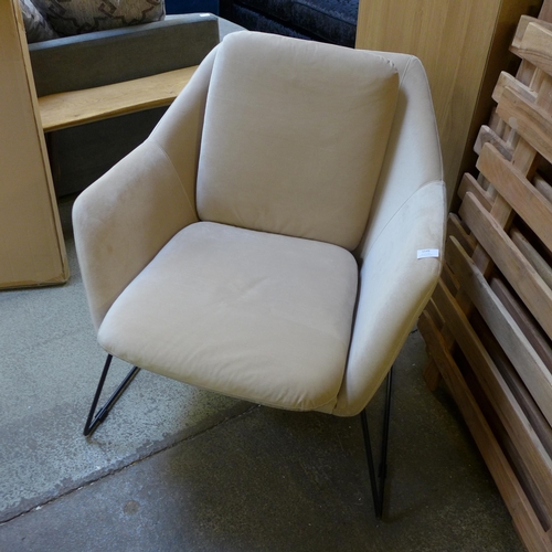 1409 - A beige velvet armchair on metal frame