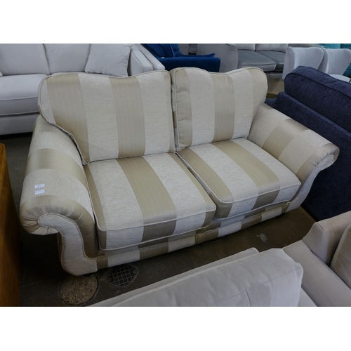 1457 - A beige and gold striped upholstered three seater sofa