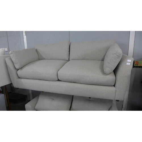 1459 - A light stone three seater sofa