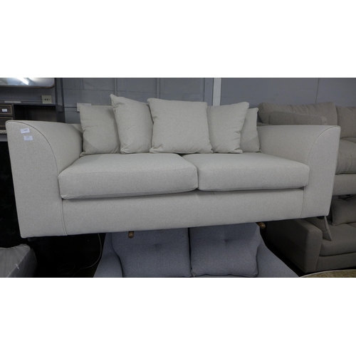 1461 - An oatmeal upholstered three seater sofa