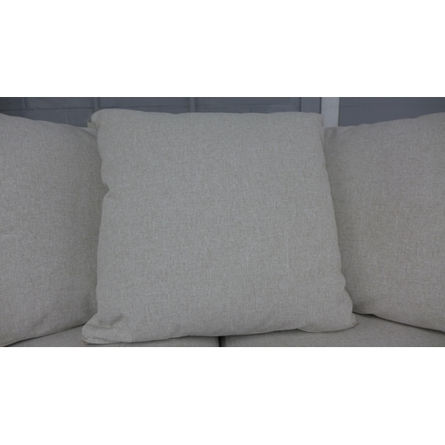 1461 - An oatmeal upholstered three seater sofa