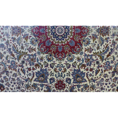 1565 - An ivory ground full pile Cashmere carpet, floral medallion design, 200cm x 300cm