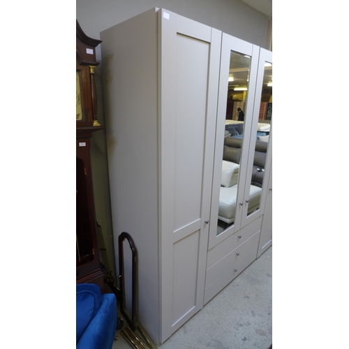 1603 - A large grey 4 door, 3 drawer floor standing wardrobe *This lot is subject to VAT