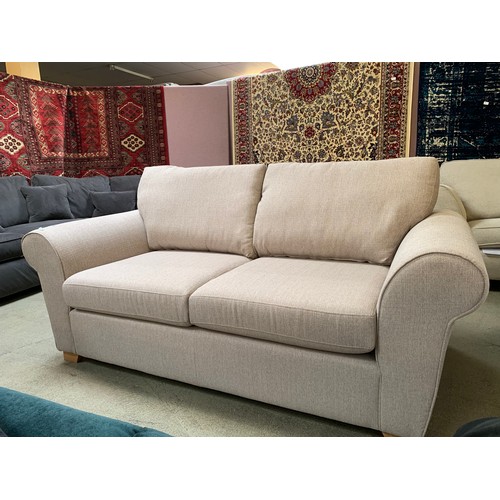 1586 - An oatmeal fabric 2.5 sofa bed (10 months old, RRP £995)