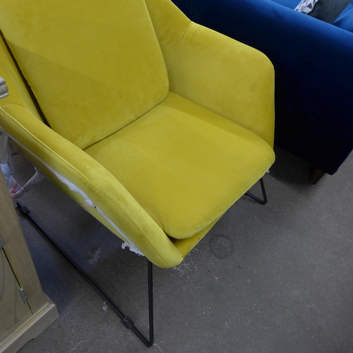 1999 - A mustard velvet armchair on metal frame - damaged corner