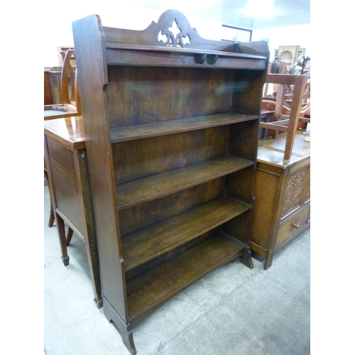 92 - An Arts and Crafts carved oak open bookcase