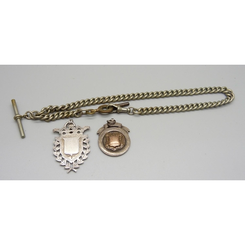 1060 - A metal Albert chain and two silver fobs