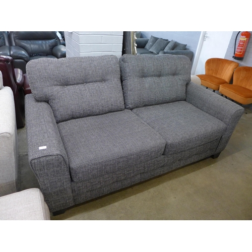 1370 - A charcoal upholstered three seater sofa