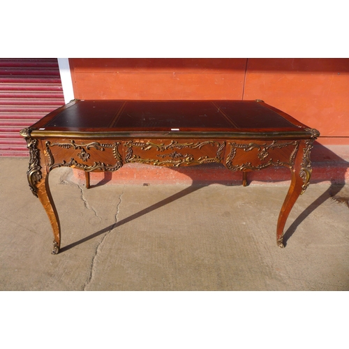 111 - A French rosewood, gilt metal mounted and black leather topped three drawer bureau plat