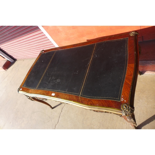 111 - A French rosewood, gilt metal mounted and black leather topped three drawer bureau plat