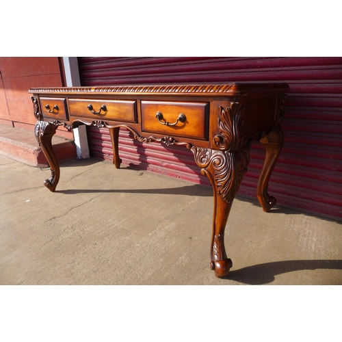 113 - A Chippendale style hardwood three drawer library desk