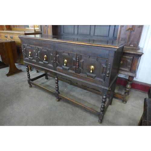 116 - An early 20th Century Jacobean Revival oak geometric moulded dresser