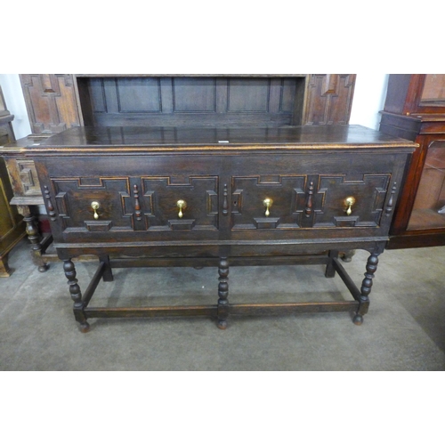 116 - An early 20th Century Jacobean Revival oak geometric moulded dresser