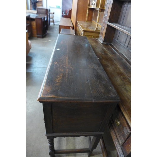 116 - An early 20th Century Jacobean Revival oak geometric moulded dresser