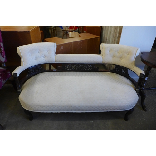 140 - An Edward VII carved mahogany and fabric upholstered salon settee