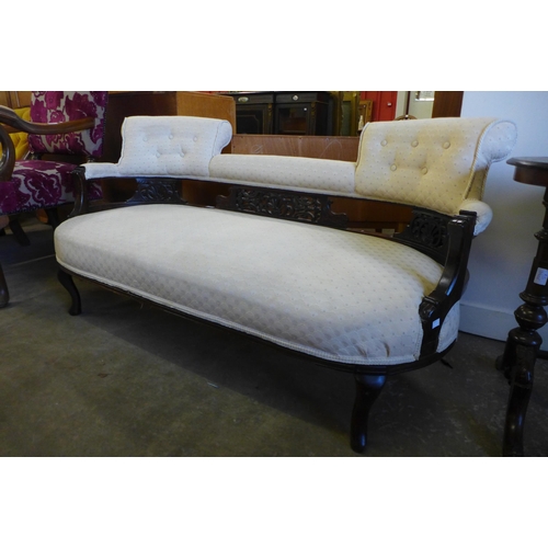 140 - An Edward VII carved mahogany and fabric upholstered salon settee