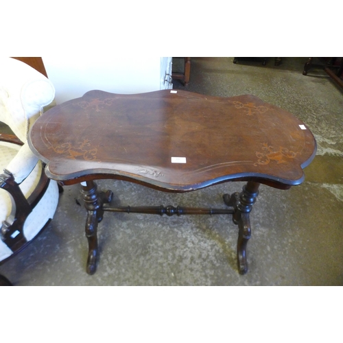 142 - A Victorian inlaid burr walnut serpentine stretcher table