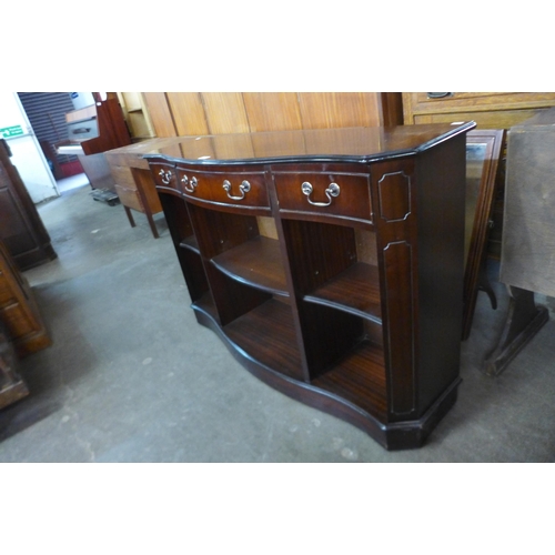 168 - An inlaid mahogany serpentine open bookcase