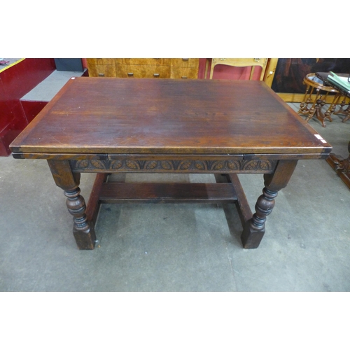 18 - A 17th Century style carved oak extending refectory table, 77cms h, 133cms l (209cms l extended), 87... 