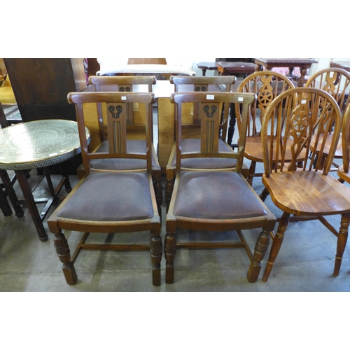 188 - A set of four oak dining chairs