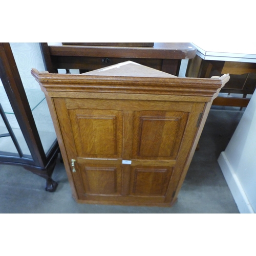 199 - An Arts and Crafts Cotswold School oak wall hanging corner cupboard