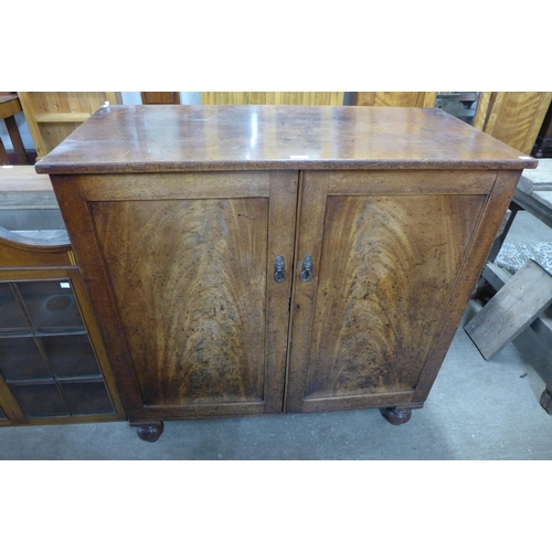 204 - A Victorian mahogany two door cupboard and a bookcase top