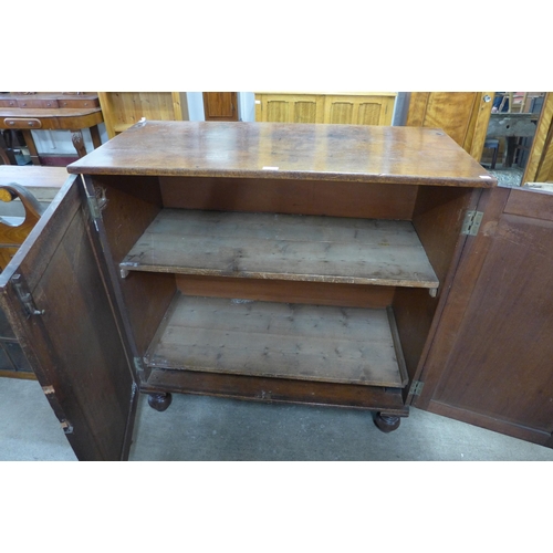 204 - A Victorian mahogany two door cupboard and a bookcase top