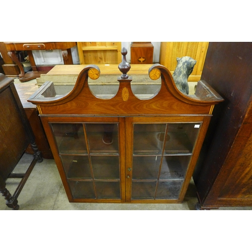 204 - A Victorian mahogany two door cupboard and a bookcase top