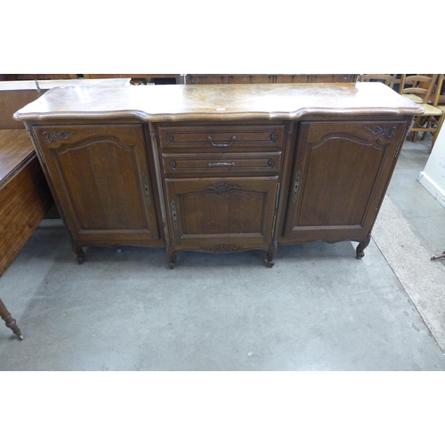 219 - A large French carved oak breakfront sideboard