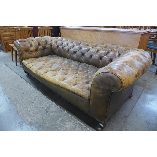 22 - A Victorian tan leather Chesterfield settee, 63cms h, 182cms w, 91cms d