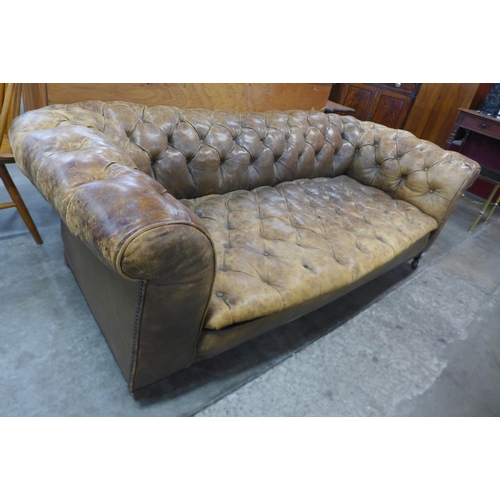 22 - A Victorian tan leather Chesterfield settee, 63cms h, 182cms w, 91cms d