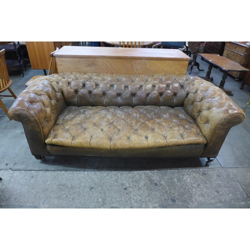 22 - A Victorian tan leather Chesterfield settee, 63cms h, 182cms w, 91cms d