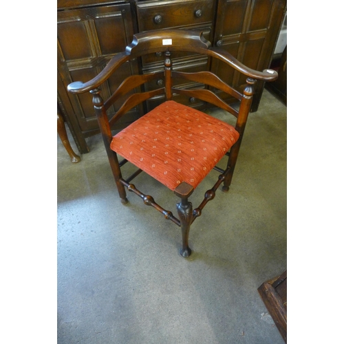 229 - A George III style carved mahogany corner chair