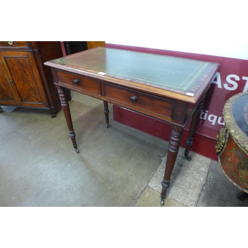 23 - A Victorian mahogany and green leather topped two drawer writing table