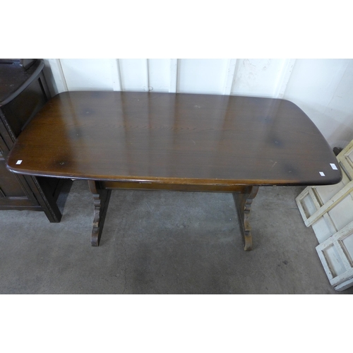 231 - An Ercol Golden Dawn elm refectory table and dresser