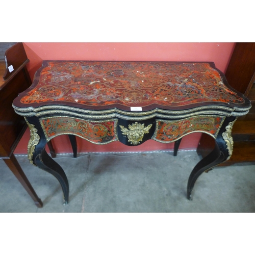 33 - A 19th Century French red Boulle, ebonised and gilt mounted fold over serpentine games table