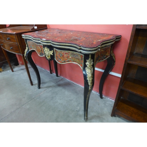 33 - A 19th Century French red Boulle, ebonised and gilt mounted fold over serpentine games table