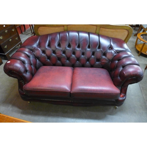 37 - A Thomas Lloyd burgundy leather Chesterfield settee