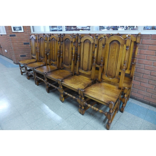 4 - A set of twelve Carolean style oak dining chairs