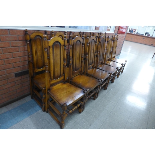 4 - A set of twelve Carolean style oak dining chairs