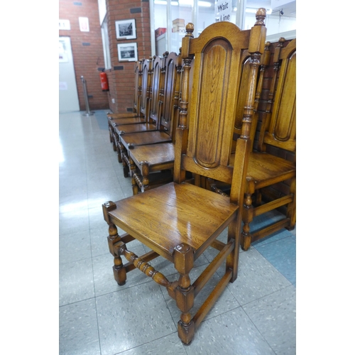 4 - A set of twelve Carolean style oak dining chairs