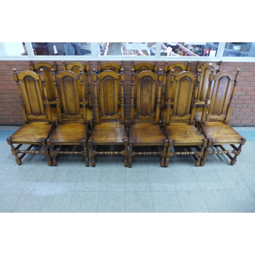 4 - A set of twelve Carolean style oak dining chairs