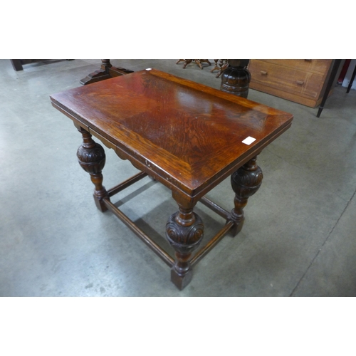 5 - A 17th Century style carved oak dwarf sized draw-leaf table, 60cms h, 70cms l, 50cms w